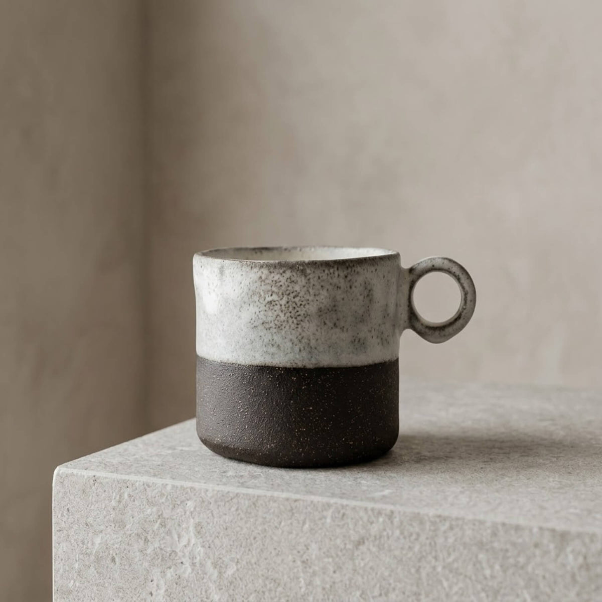 Hand-built two-tone artisan ceramic mug with circular handle and raw glaze finish by Authentico Ceramics.